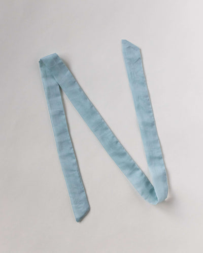 Haarband aus Baumwollseide in himmelblau von Curly'N'Covered vor weißem Hintergrund ausgelegt